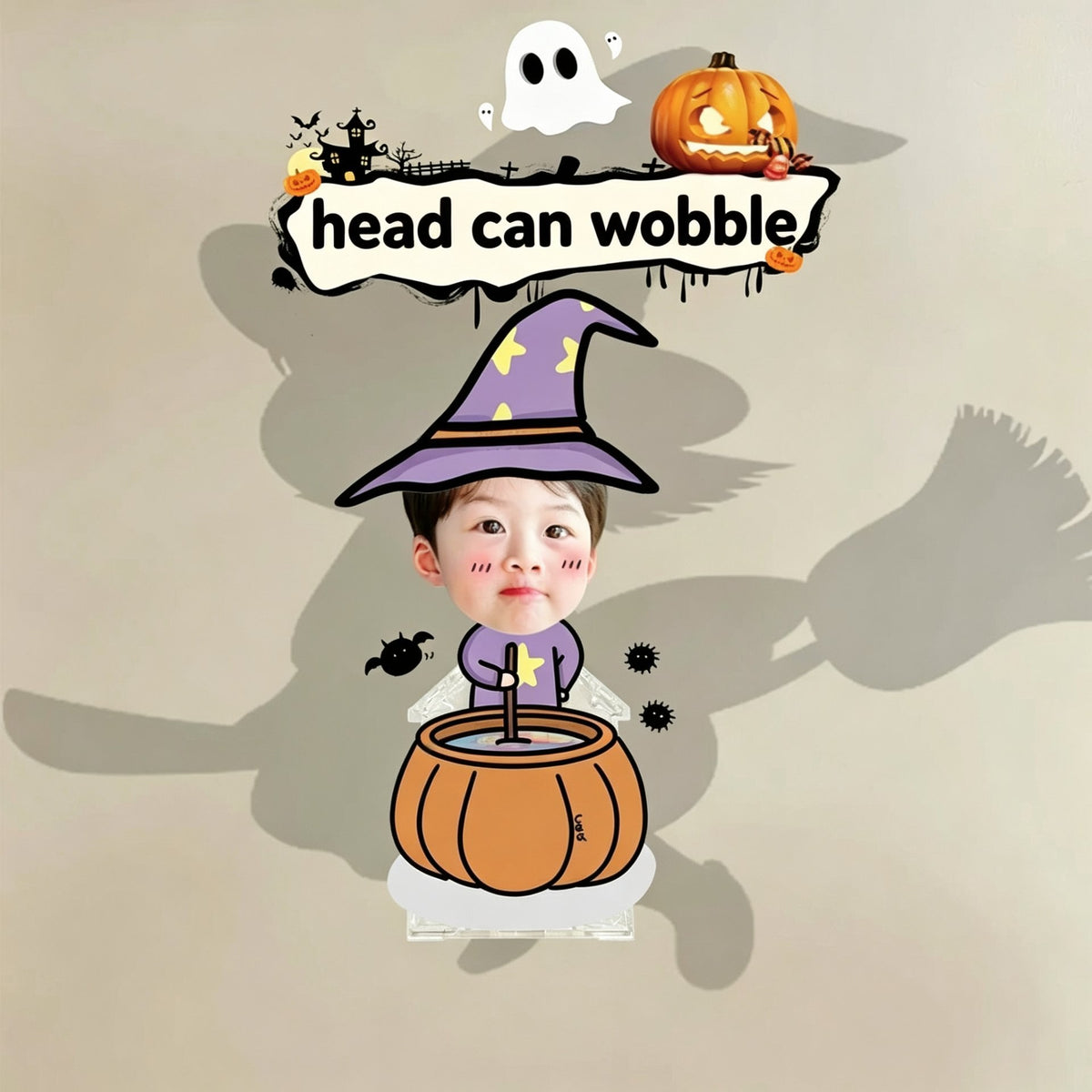 Custom little wizard cauldron photo wobble figure — little boy in a purple star witch hat stirring a pumpkin cauldron with bats around, personalized Halloween wobbling desk ornament