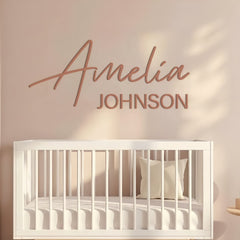 Custom girl name sign in terracotta acrylic above a nursery dresser
