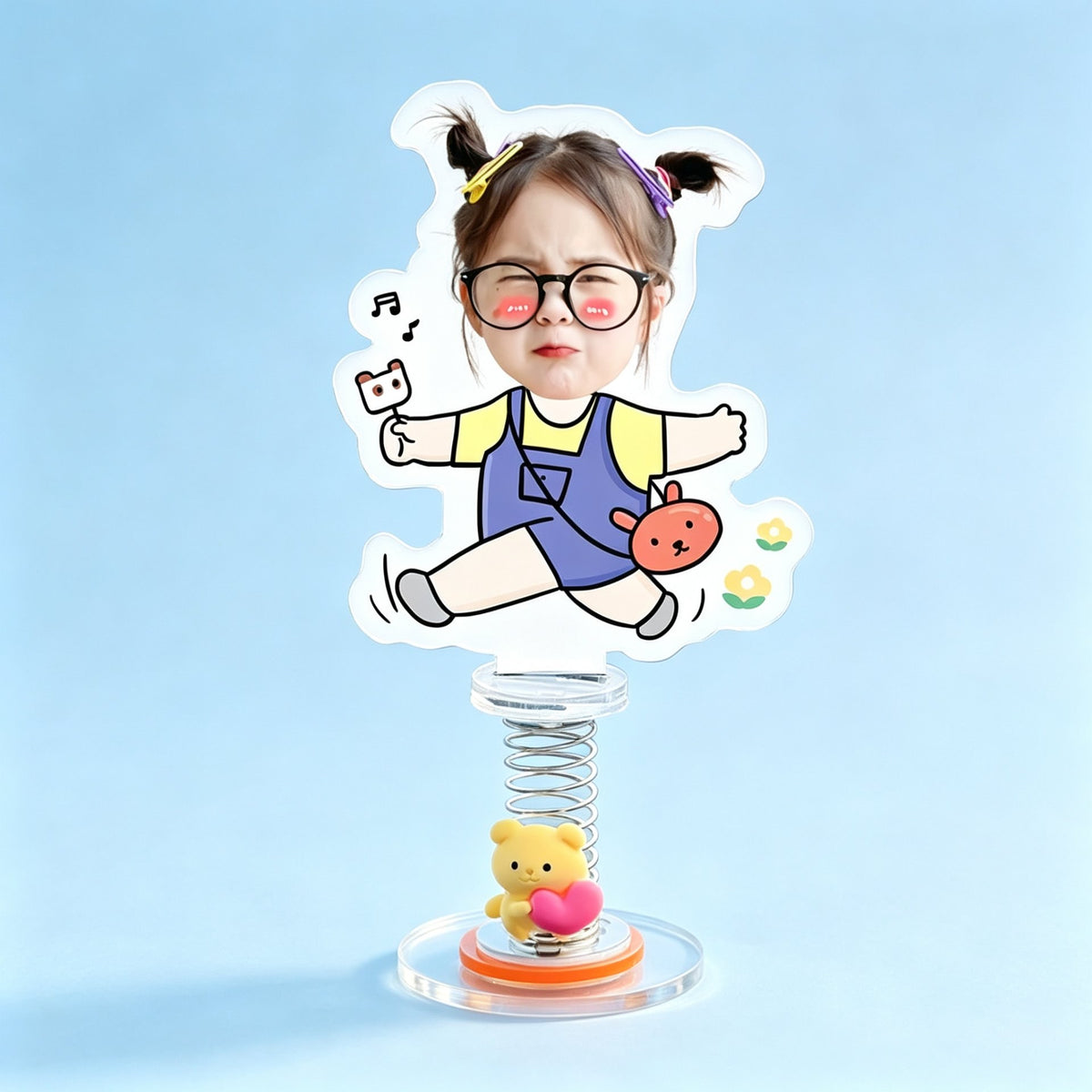 Custom jumping toddler photo spring bobblehead — funny toddler with glasses mid-jump in denim overalls with a bunny bag and music notes, acrylic figure bouncing on a spring base