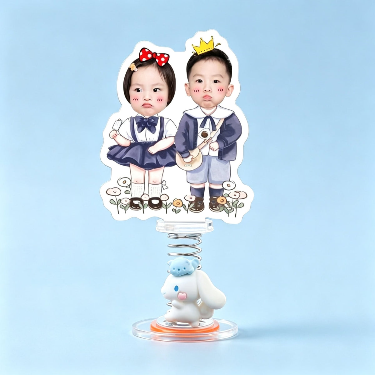 Custom navy duo photo spring bobblehead — girl with a red bow and navy tutu beside a boy with a golden crown among hand-drawn flowers, acrylic figure bouncing on a spring base