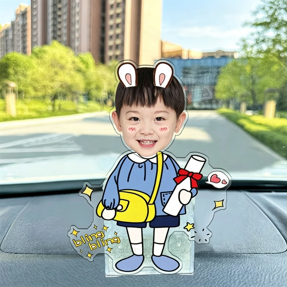 Custom bunny ear boy photo wobble figure — happy boy with bunny ear headband holding a diploma scroll and yellow bag, bling bling stars, personalized wobbling desk ornament