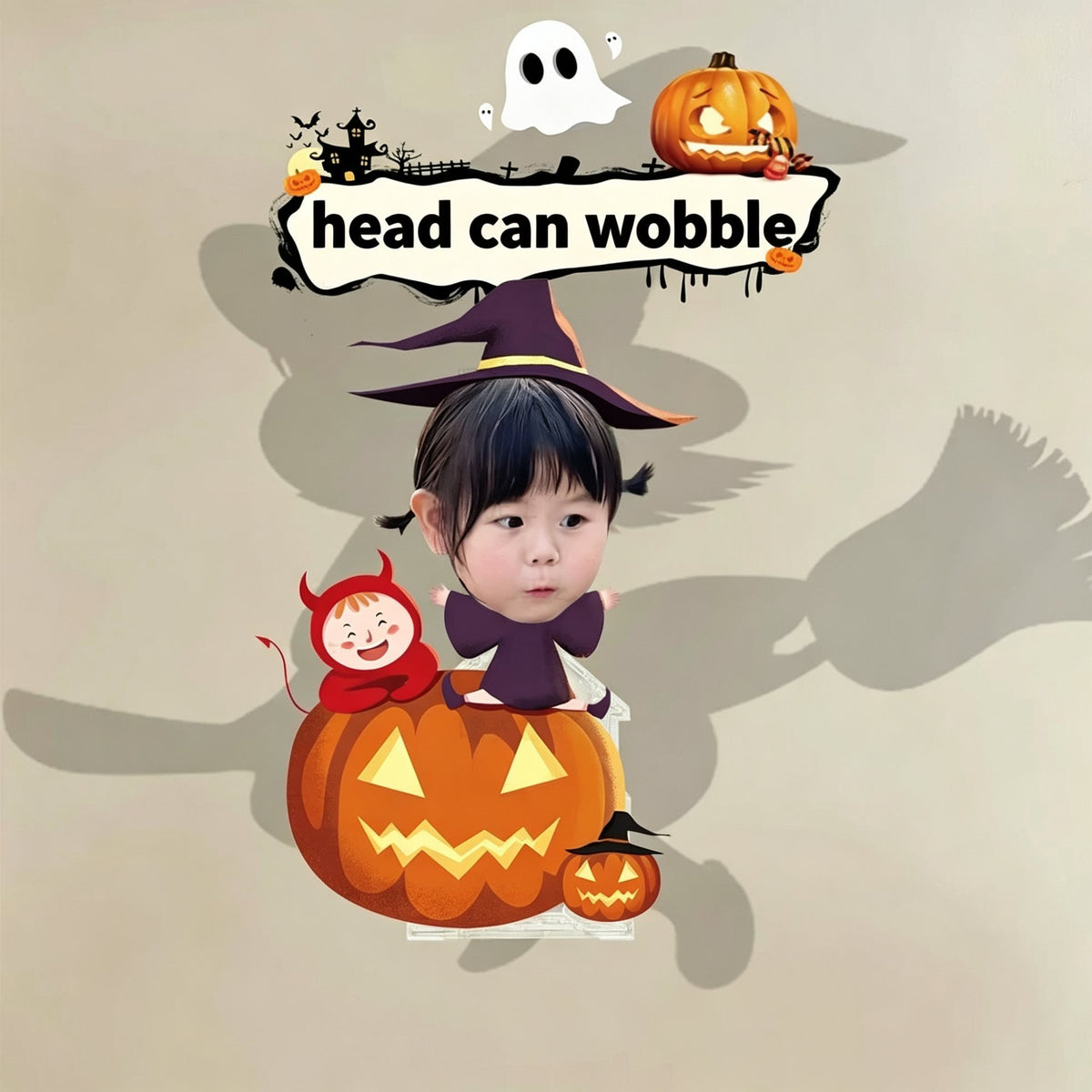 Custom pumpkin sit witch photo wobble figure — little girl in a purple witch hat sitting on a carved jack-o'-lantern with a little red devil, personalized Halloween desk ornament