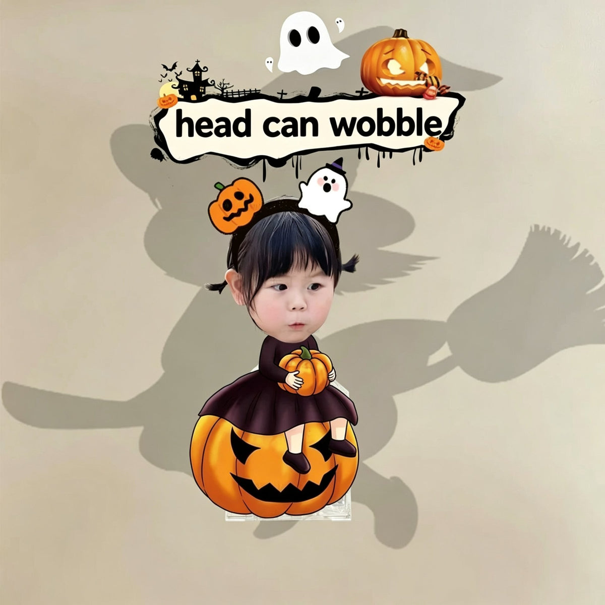 Custom witch pumpkin photo wobble figure — little girl in witch costume sitting on a carved jack-o'-lantern with a ghost and pumpkin headband, personalized Halloween wobbling desk ornament