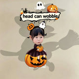 Custom witch pumpkin photo wobble figure — little girl in witch costume sitting on a carved jack-o'-lantern with a ghost and pumpkin headband, personalized Halloween wobbling desk ornament
