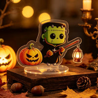 Halloween Frankenstein acrylic standee sensor light — cute green monster with stitches holding a lantern that glows with LED light, motion-activated acrylic desk decoration
