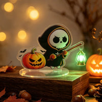 Halloween ghost acrylic standee sensor light — cute hooded ghost holding a lantern glowing with green LED light, motion-activated acrylic desk decoration
