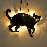 Halloween black cat acrylic wall art light — arched black cat silhouette with bright eyes glowing with warm LED fairy lights