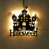 Halloween castle acrylic wall art light — haunted castle silhouette with a Halloween lettering sign glowing with warm LED fairy lights on a wall