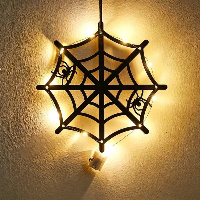 Halloween spider web acrylic wall art light — black cobweb with two crawling spiders glowing with warm LED fairy lights