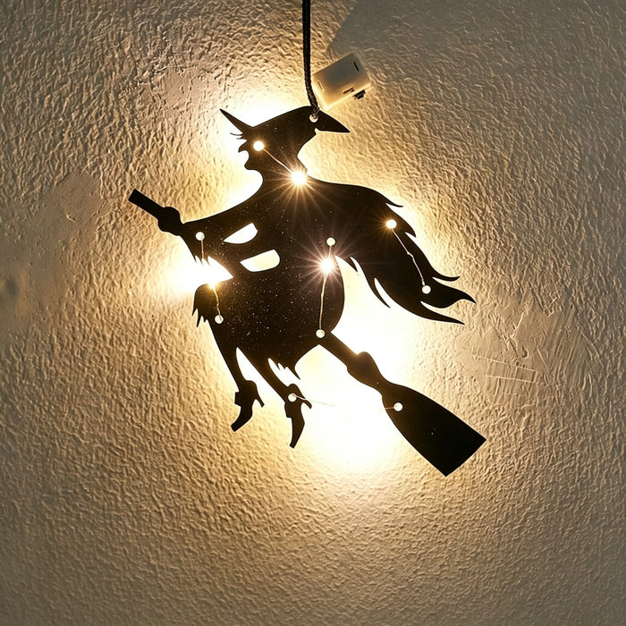 Halloween witch acrylic wall art light — witch flying on a broomstick silhouette glowing with warm LED fairy lights on a wall